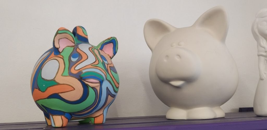 painted and unpainted pottery pigs